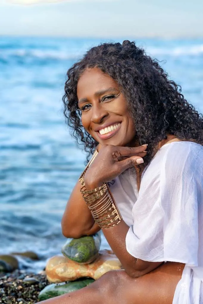 Subhadra smiling on the shore in Jamaica