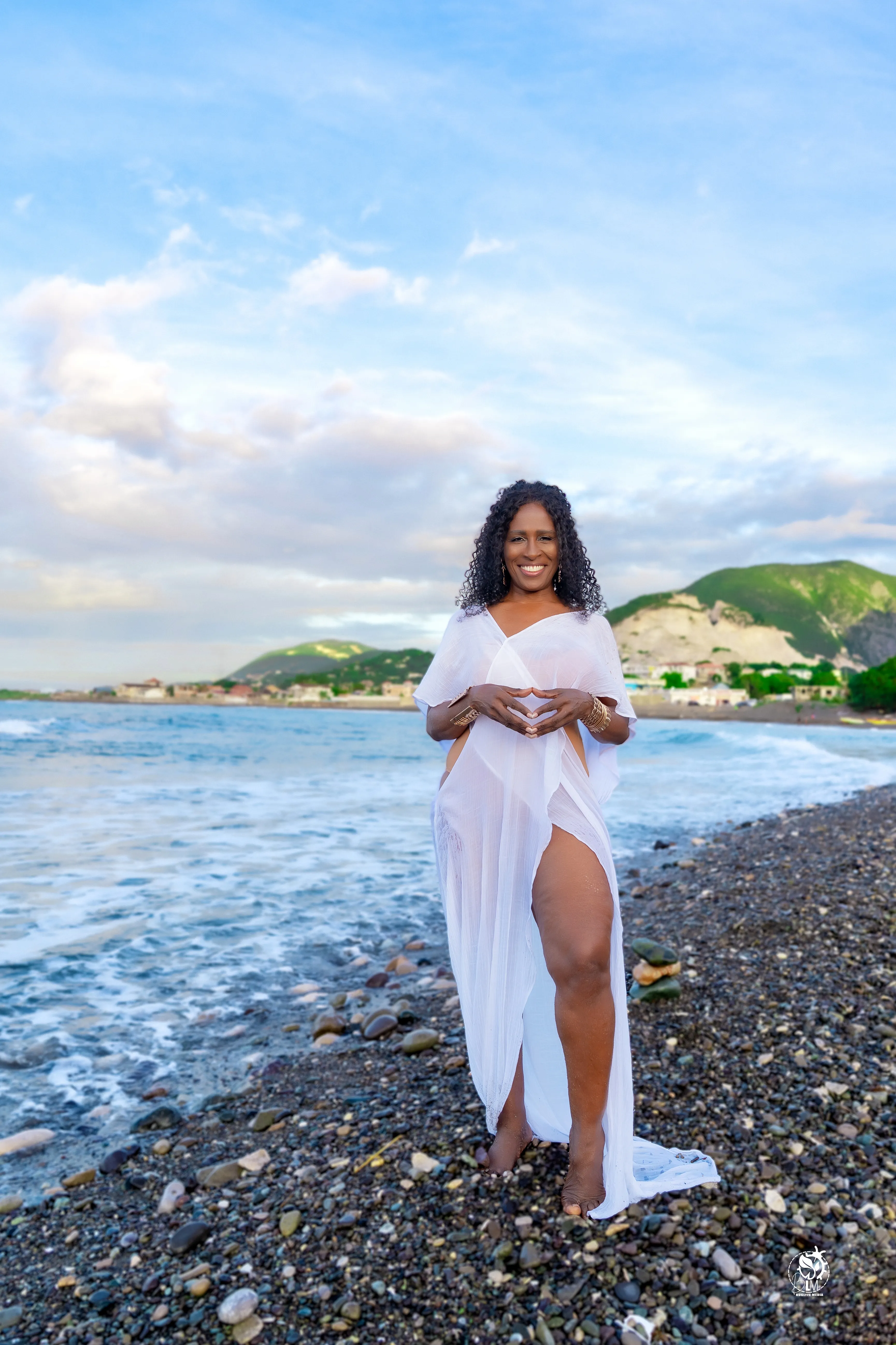 Subhadra (Sandra Griffiths), founder of Yoga Angels International, standing on a Jamaican beach