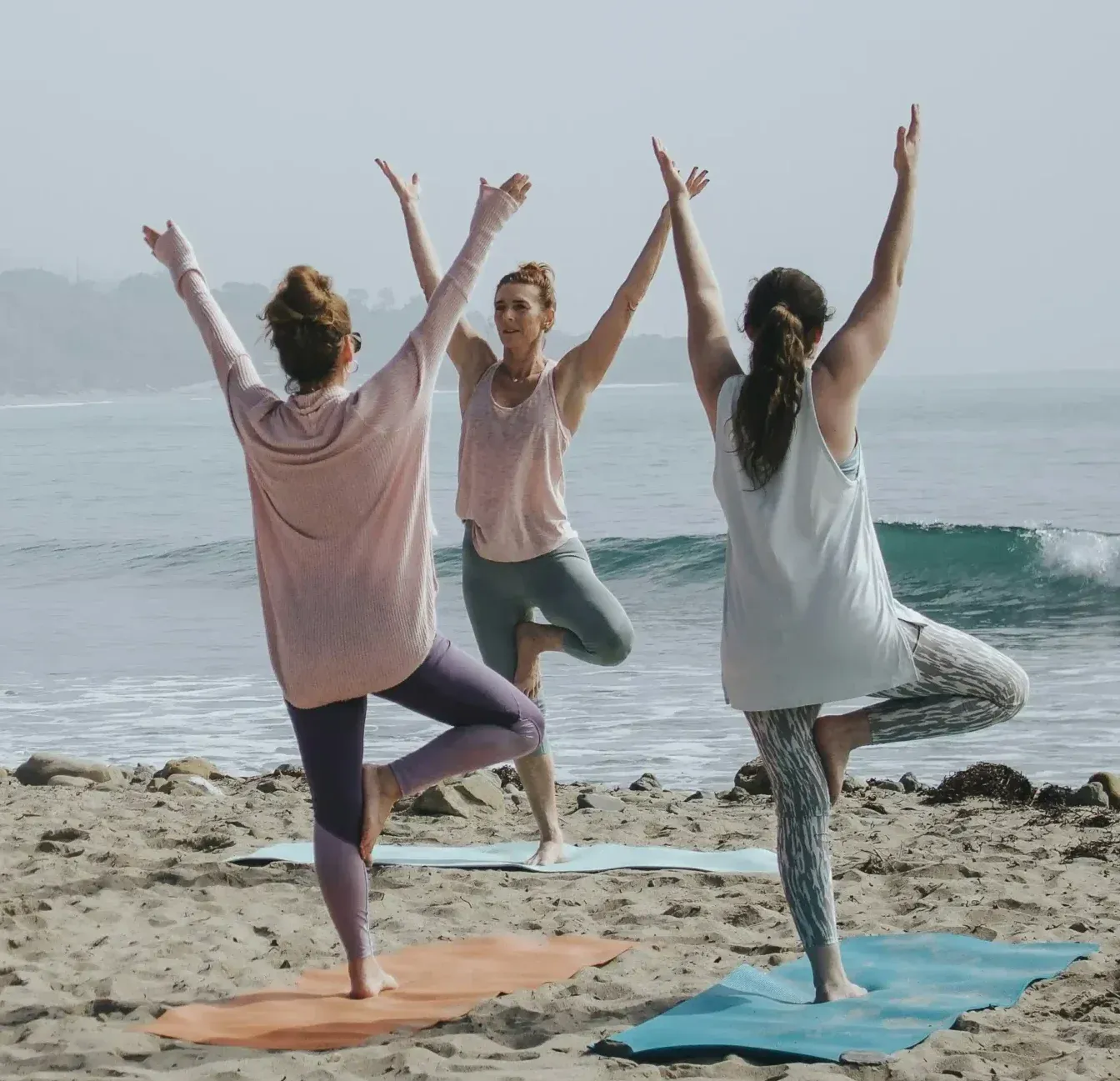 Yoga Angels students practising together beside the Caribbean Sea
